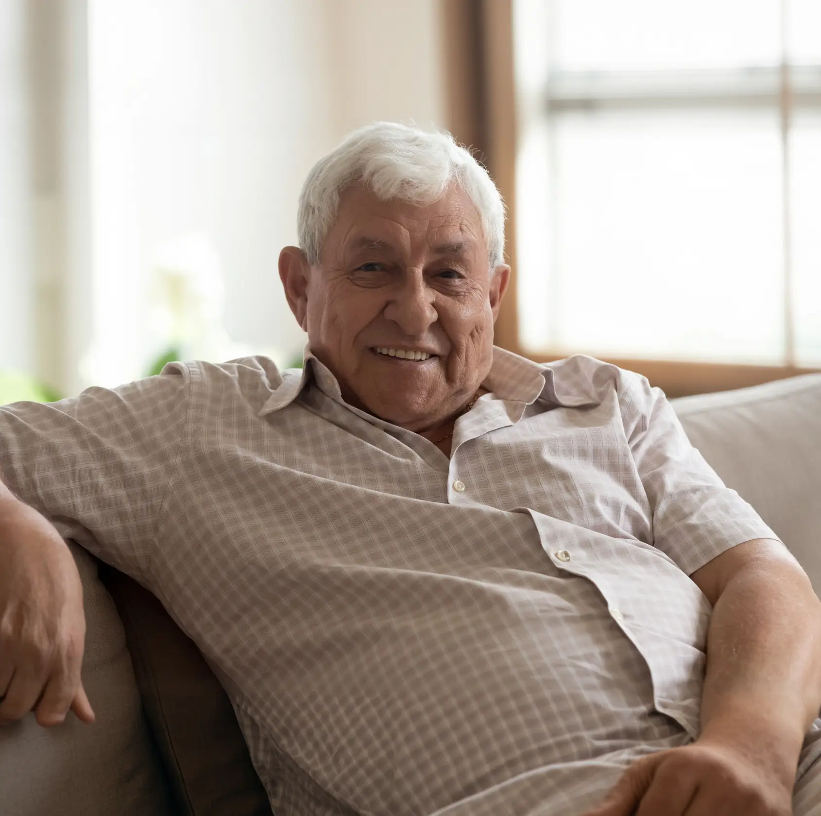 A smiling senior dental implant patient at Sunrise Dental in Richardson, TX